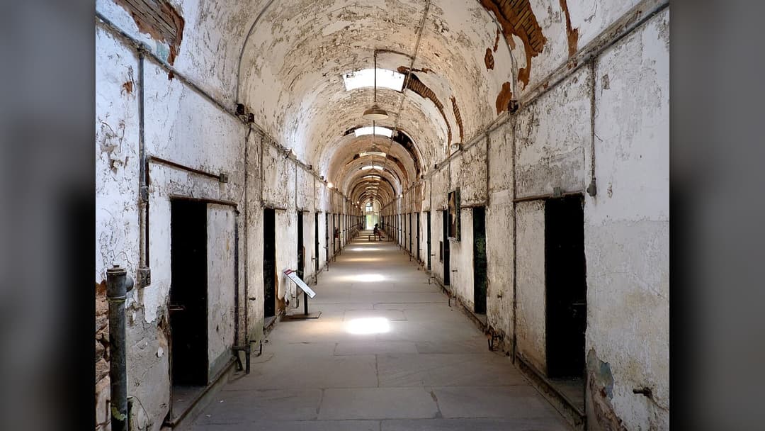 Crumbling stone cellblock corridor inside Eastern State Penitentiary in Philadelphia, Pennsylvania