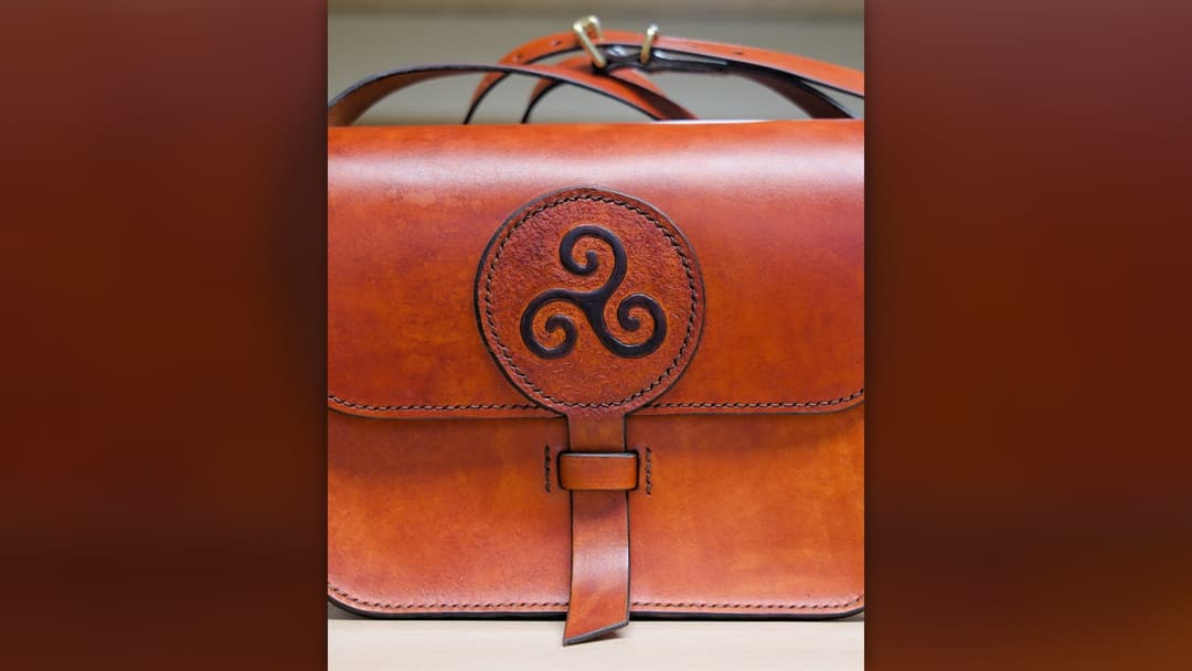 Structured leather handbag placed carefully on a flat surface