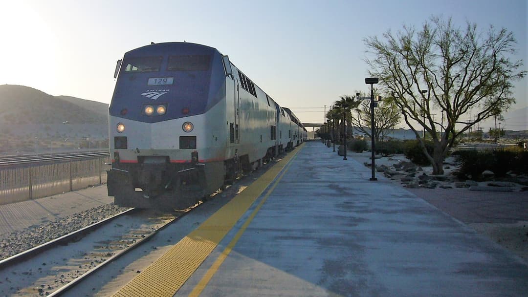 Amtrak's Sunset Limited passenger train arriving at Palm Springs station in California.