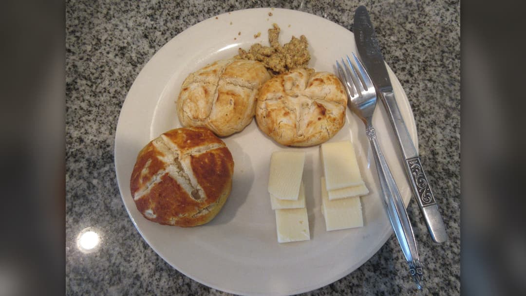 Warm soft pretzel rolls and bites served with savory cheese dip
