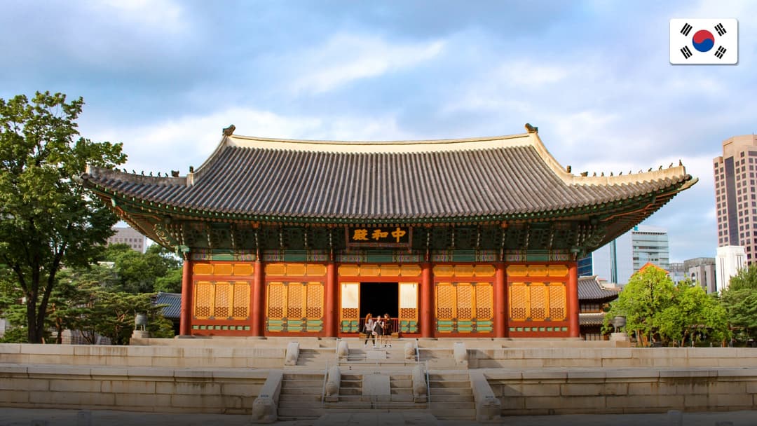 Historic Gyeongbokgung palace juxtaposed against modern downtown Seoul skyscrapers.