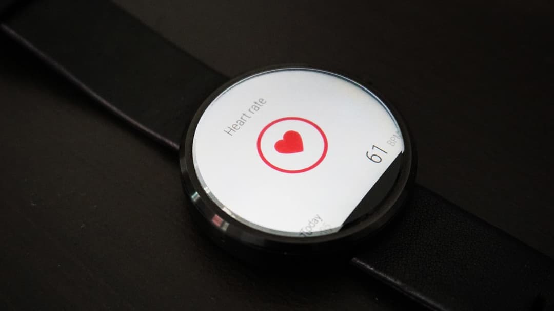 Landscape photograph of a smartwatch displaying a spiking heart rate and calorie monitor