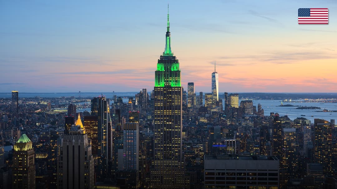 The iconic Manhattan skyline featuring the Empire State Building glowing at twilight.