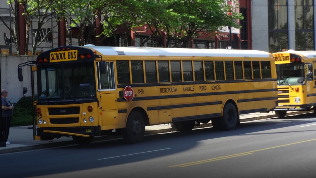 Children boarding a classic American yellow school bus.