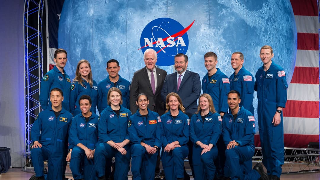 Group portrait of the 2017 class of NASA astronauts in blue flight suits at Johnson Space Center