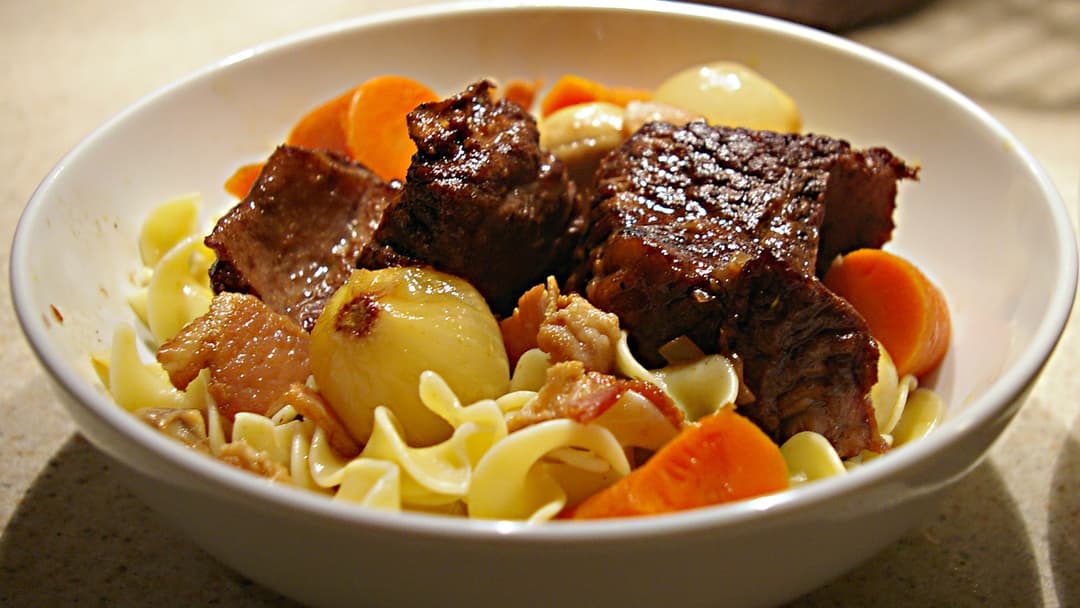 Braised beef short ribs plated with gourmet sides