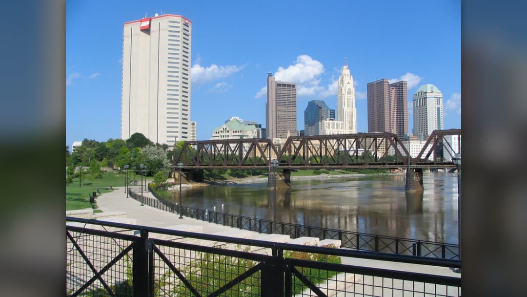Downtown Columbus Ohio skyline reflected in the Scioto River on a clear day