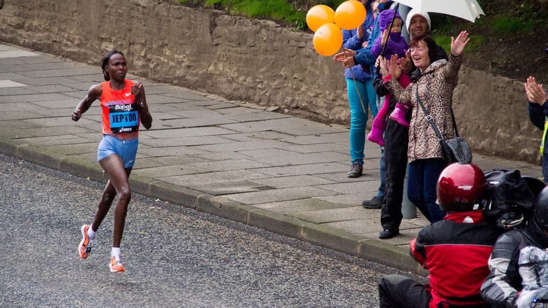 An elite marathon runner pacing an athletic distance event with high endurance.