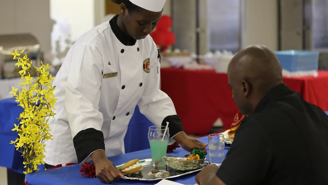 A culinary chef tasting and balancing fine flavor seasonings.