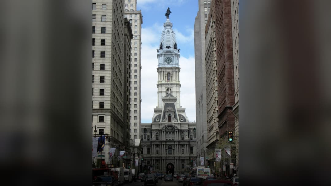 Street-level perspective looking north on Broad Street toward historic Philadelphia City Hall.