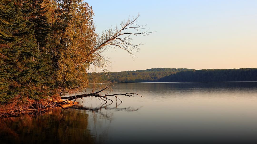 Serene sunset over Lake Superior and sandy beaches at Pictured Rocks National Lakeshore.