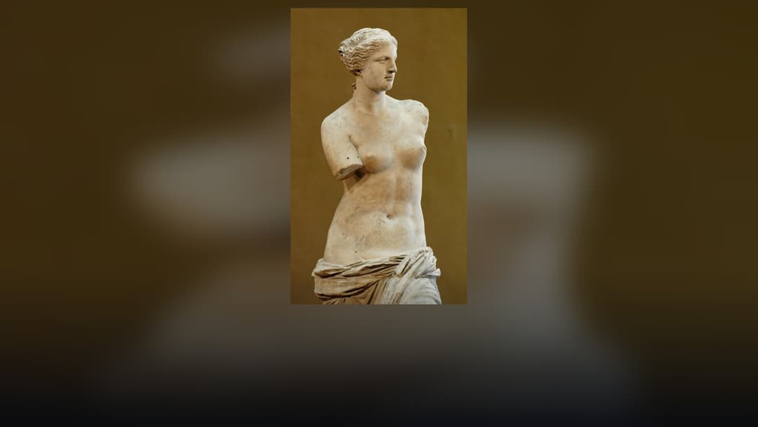 Ancient Greek marble statue of Venus de Milo on display at the Louvre Museum.