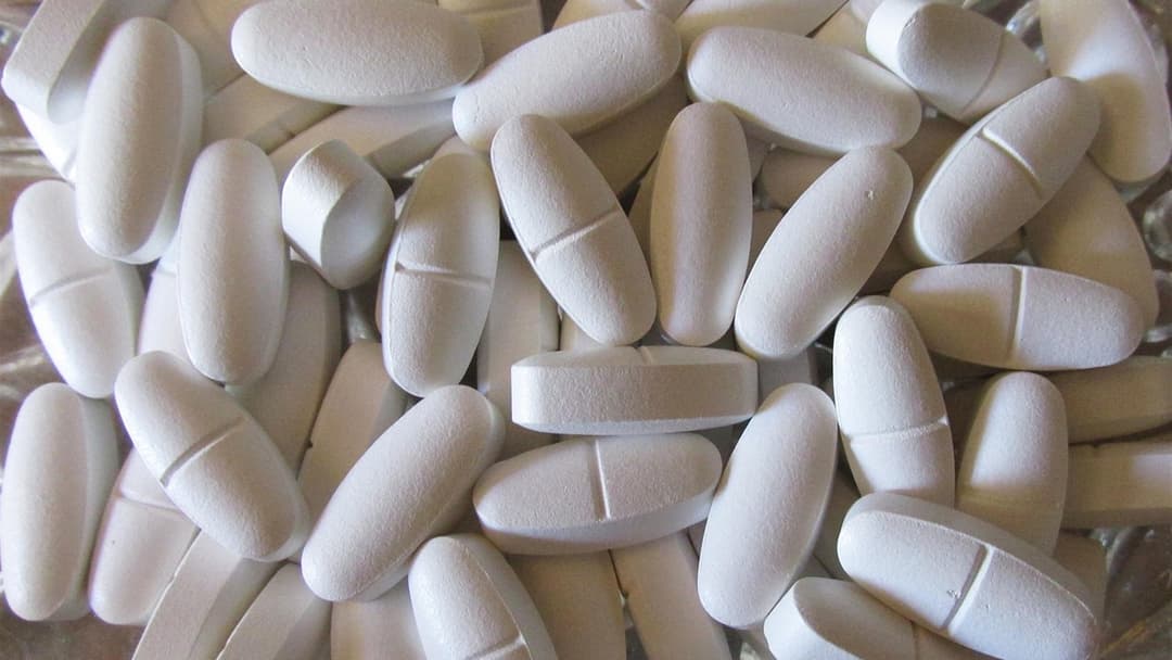 Bone-strengthening mineral supplements arranged with wholesome foods on a table.