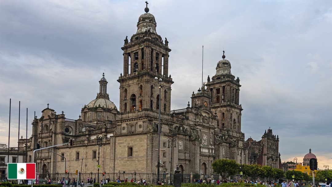Mexico City Metropolitan Cathedral on the Zocalo plaza with flag of Mexico in bottom-left corner