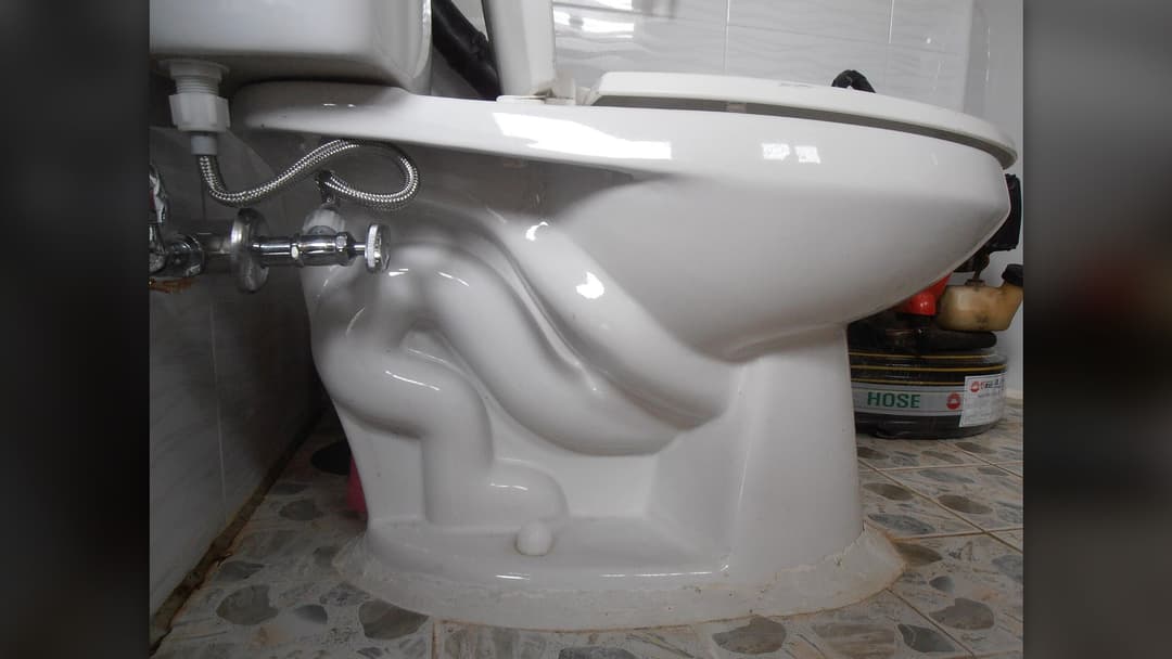 Siphonic flush toilet bowl showing high standing water level