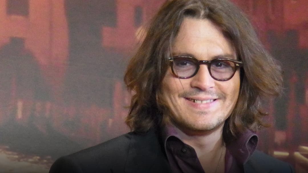 Johnny Depp smiling at a premiere.
