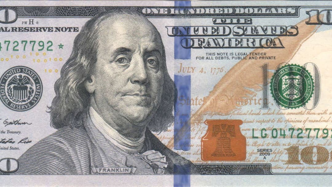 Close-up of 100 US Dollar banknotes and paper currency.