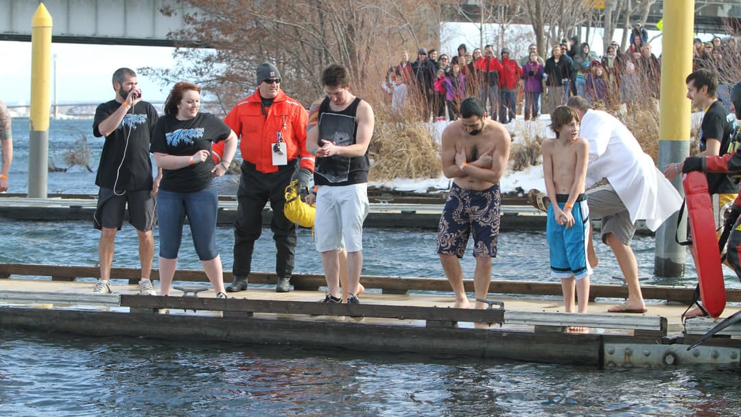 Winter swimmers braving near-freezing cold water conditions.