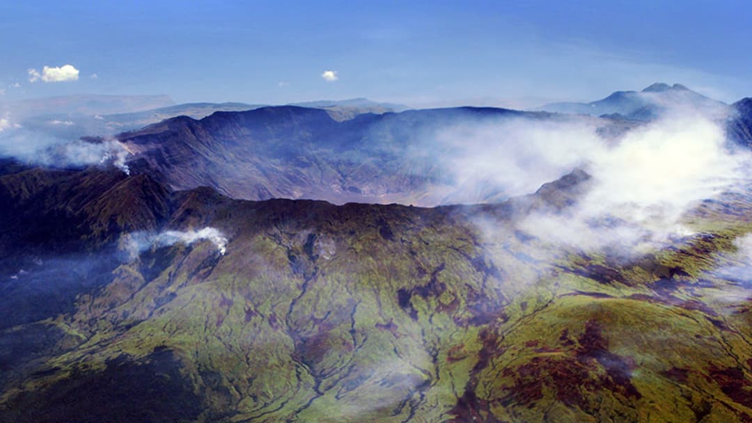 Aerial view of the deep summit caldera of Mount Tambora on Sumbawa Island, Indonesia.