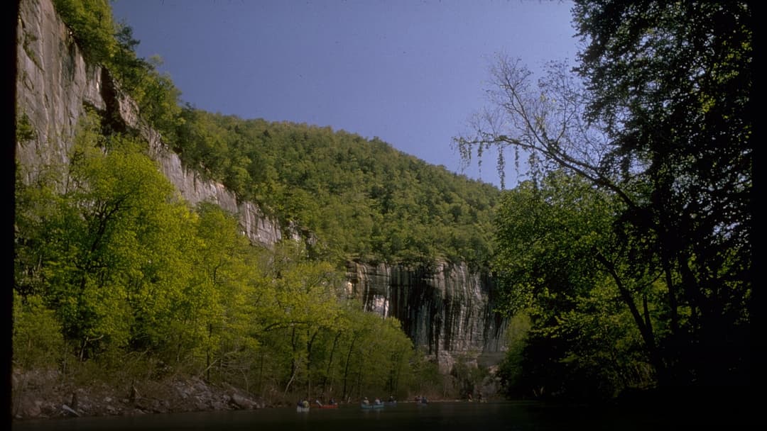 Soaring limestone river bluffs overlooking the serene Buffalo National River in the Ozarks.
