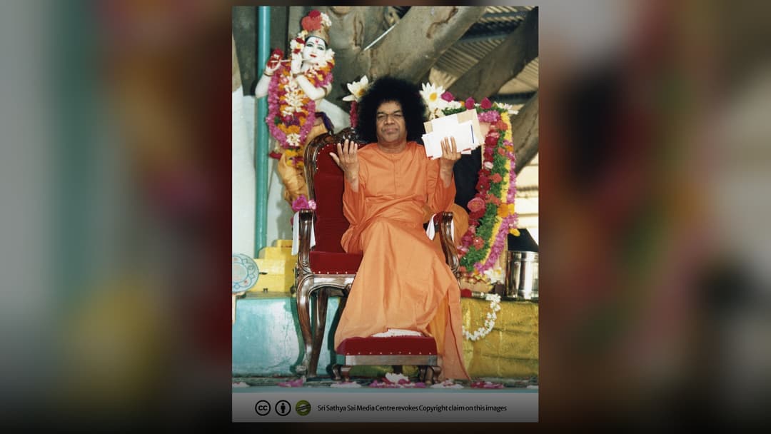 Indian spiritual leader Sathya Sai Baba wearing his traditional saffron robes.