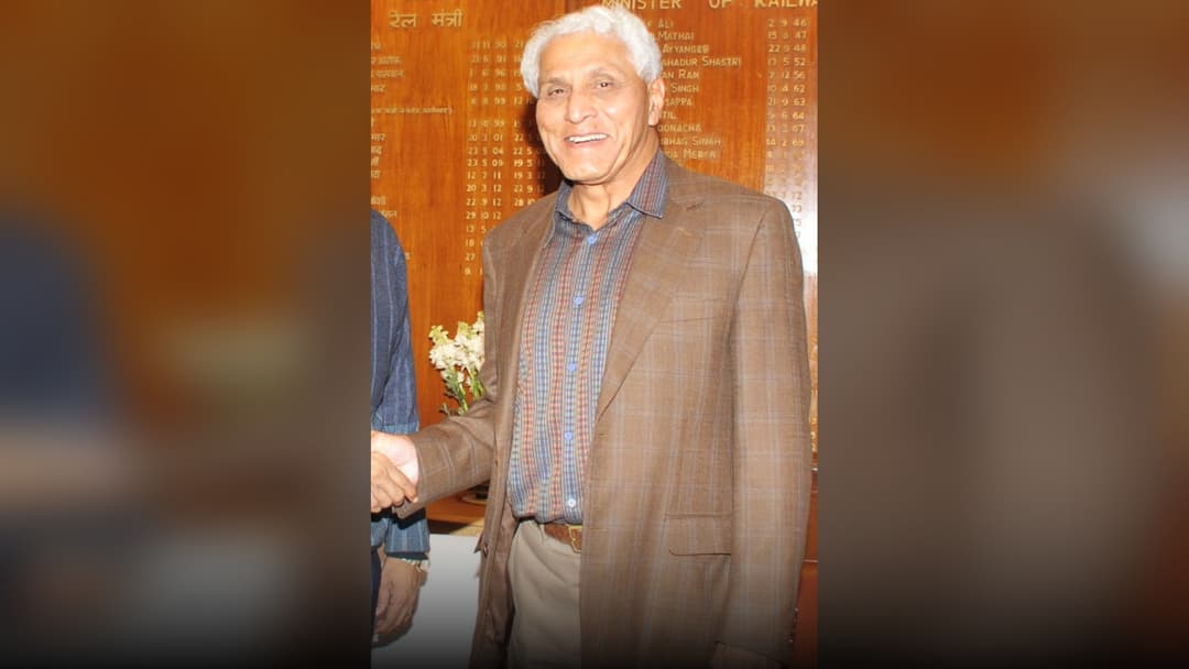 Dr. Romesh Wadhwani in a professional business suit.