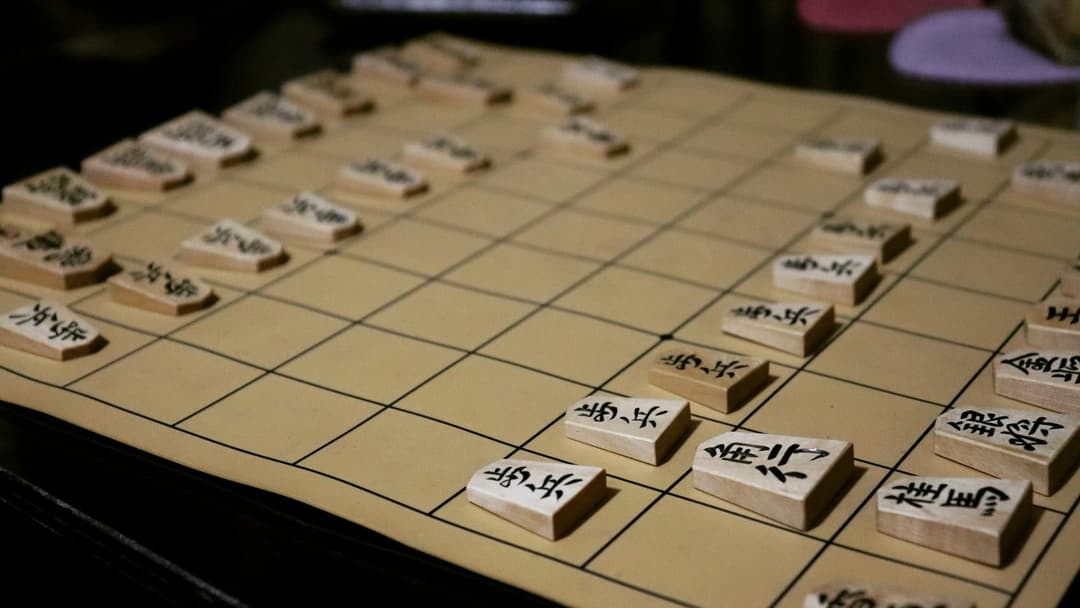 Japanese Shogi board with wooden pentagonal pieces aligned for play