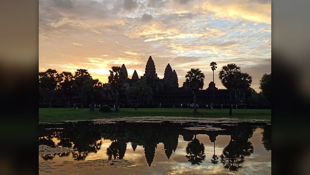 Angkor Wat temple towers illuminated by sunrise light