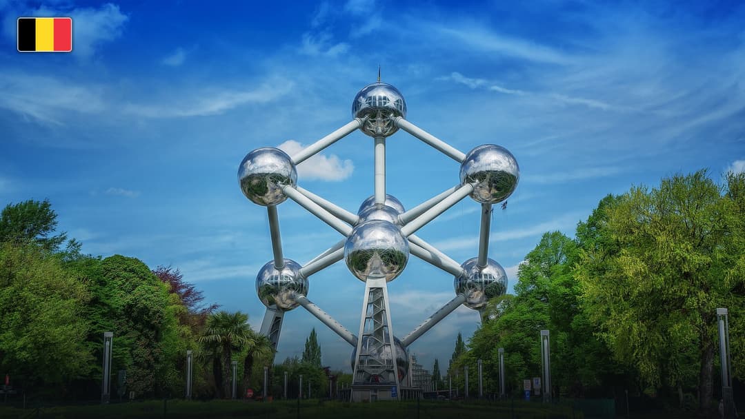 The futuristic stainless steel spheres of the Atomium in Brussels, with the flag of Belgium.
