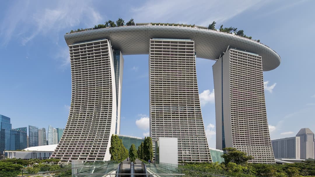 The iconic three soaring towers and rooftop SkyPark surfboard of Marina Bay Sands in Singapore.