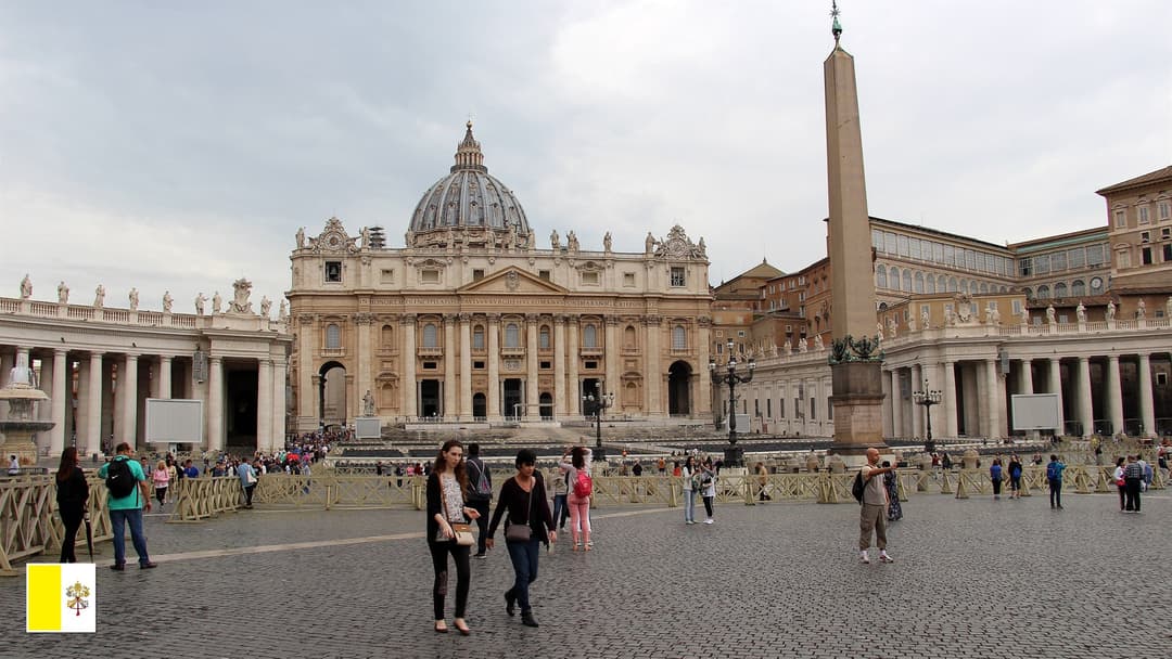 St. Peter's Basilica dome and Piazza San Pietro in Vatican City with flag of Vatican City in bottom-left corner