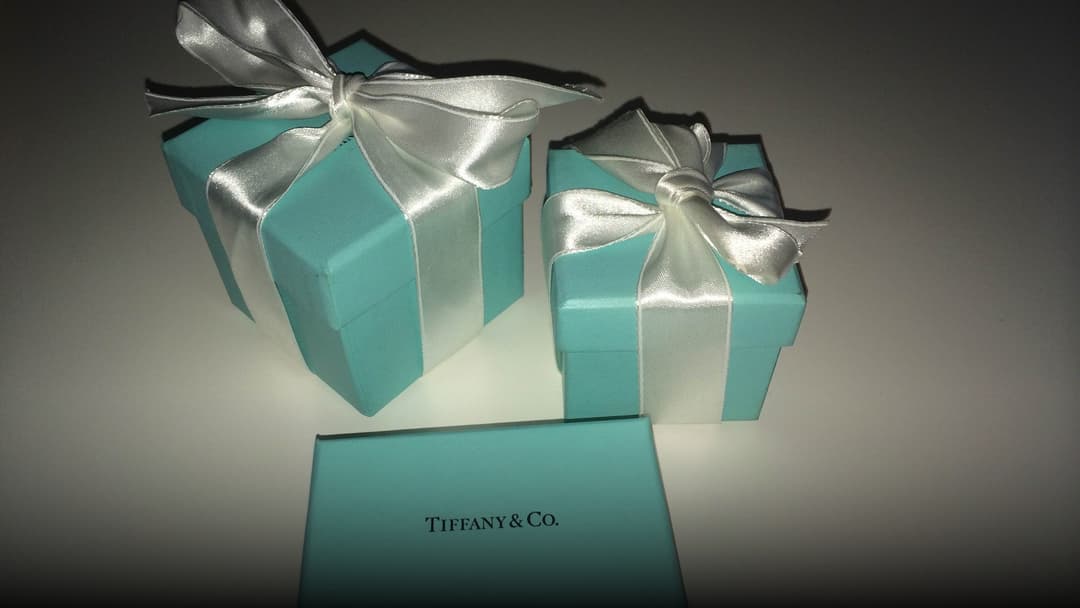 Classic Tiffany and Co. robin egg blue jewelry gift boxes tied with white satin ribbons.