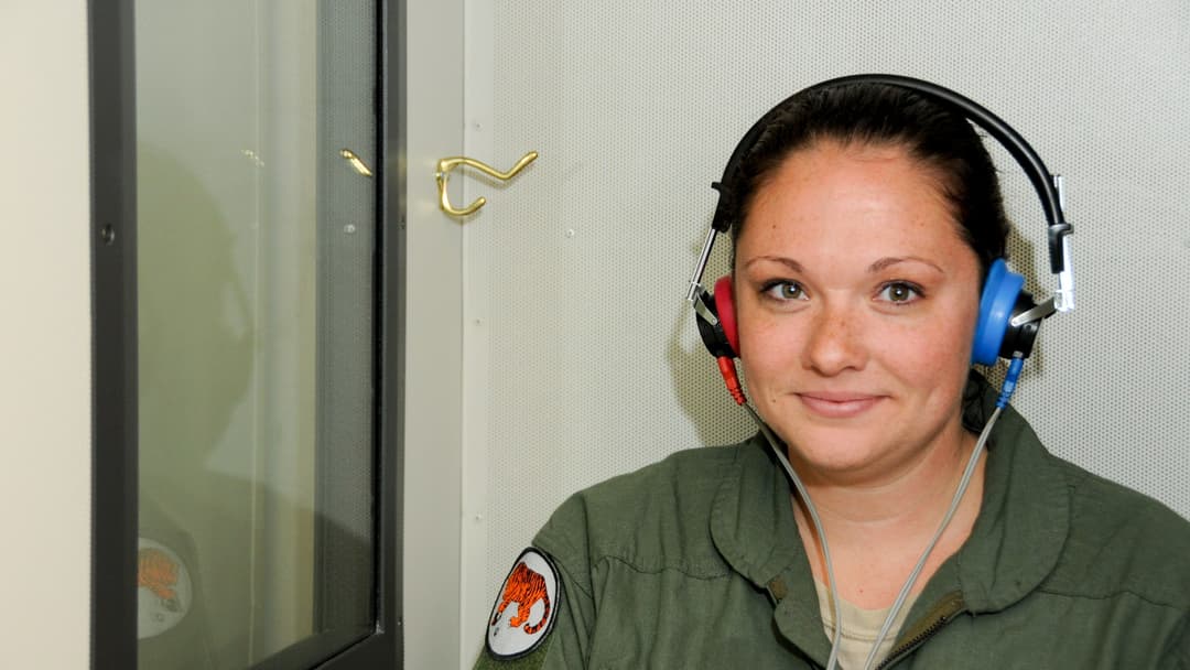 A clinician conducting a clinical hearing evaluation and auditory frequency exam.