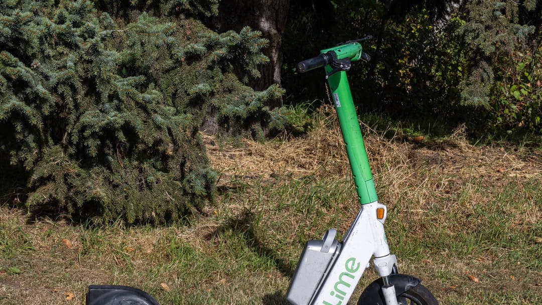 Green and white Lime shared electric scooter parked in Edmonton, Alberta