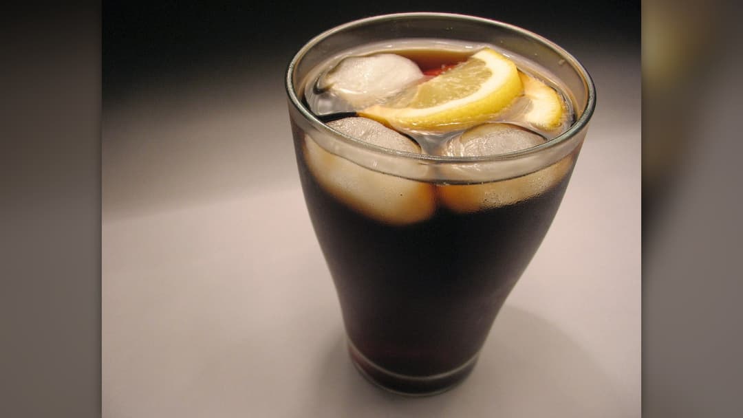 Glass of carbonated cola with ice