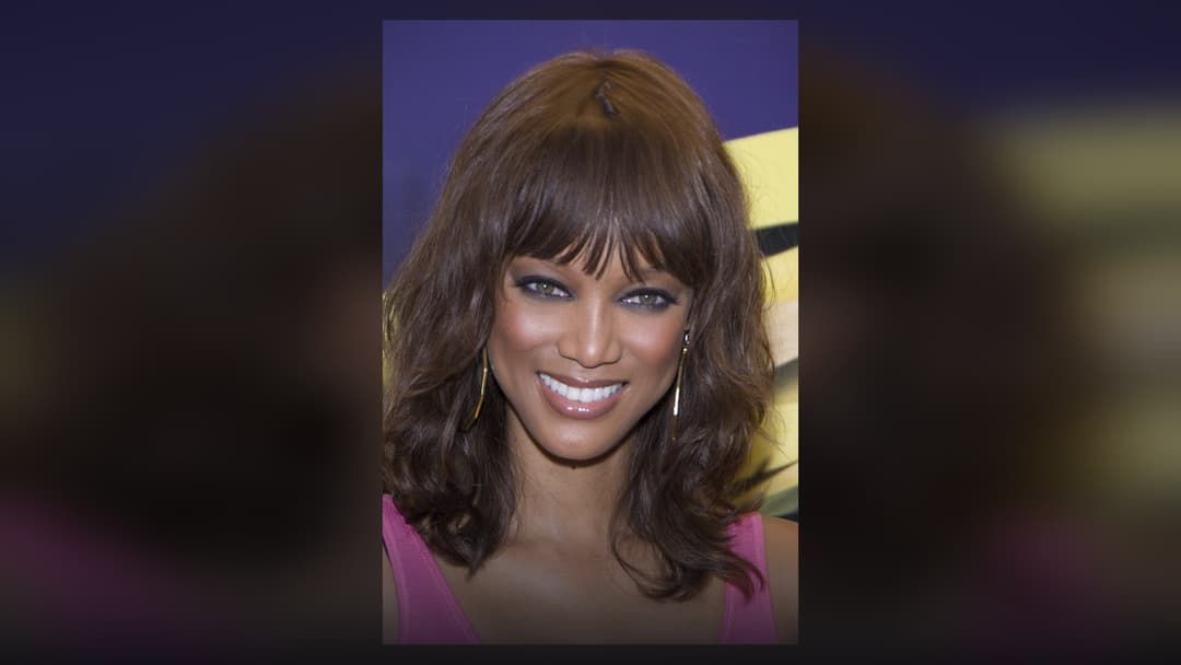 Tyra Banks posing stylishly at a red carpet event