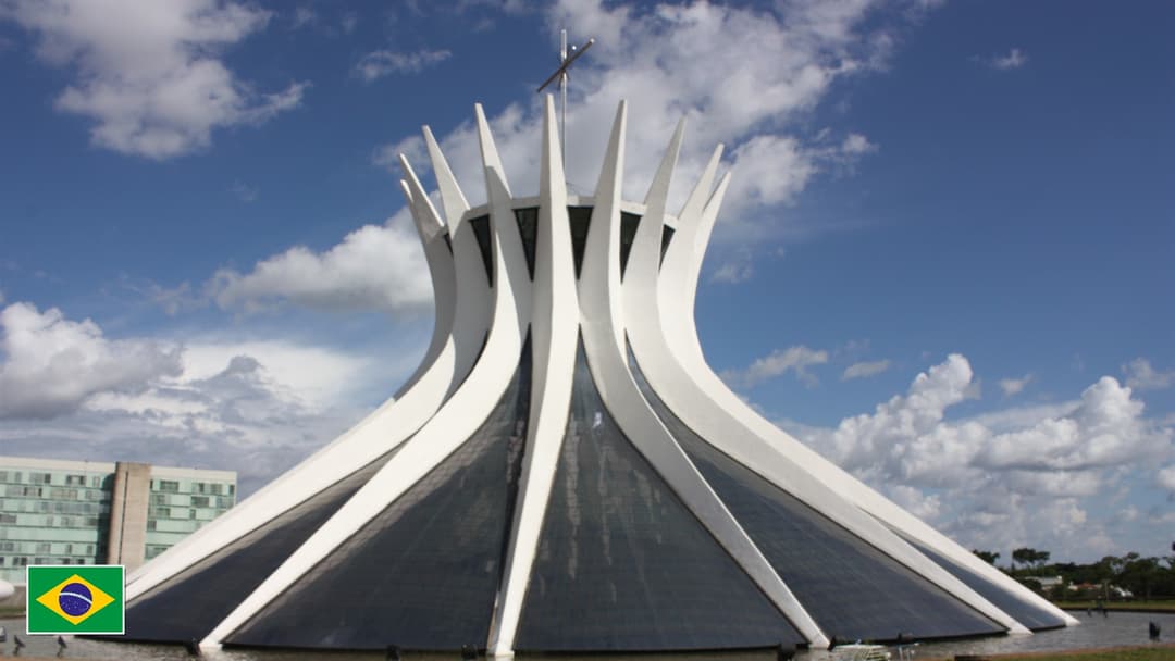 Cathedral of Brasilia hyperbolic concrete columns with flag of Brazil in bottom-left corner