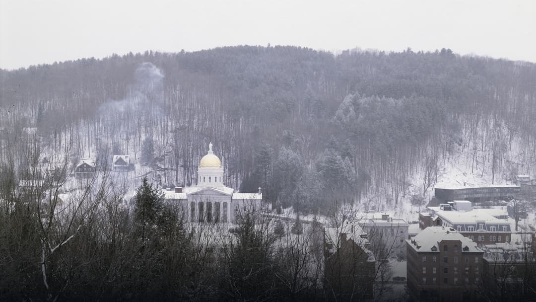 The Vermont State House with its gold dome surrounded by deep snow in Montpelier.
