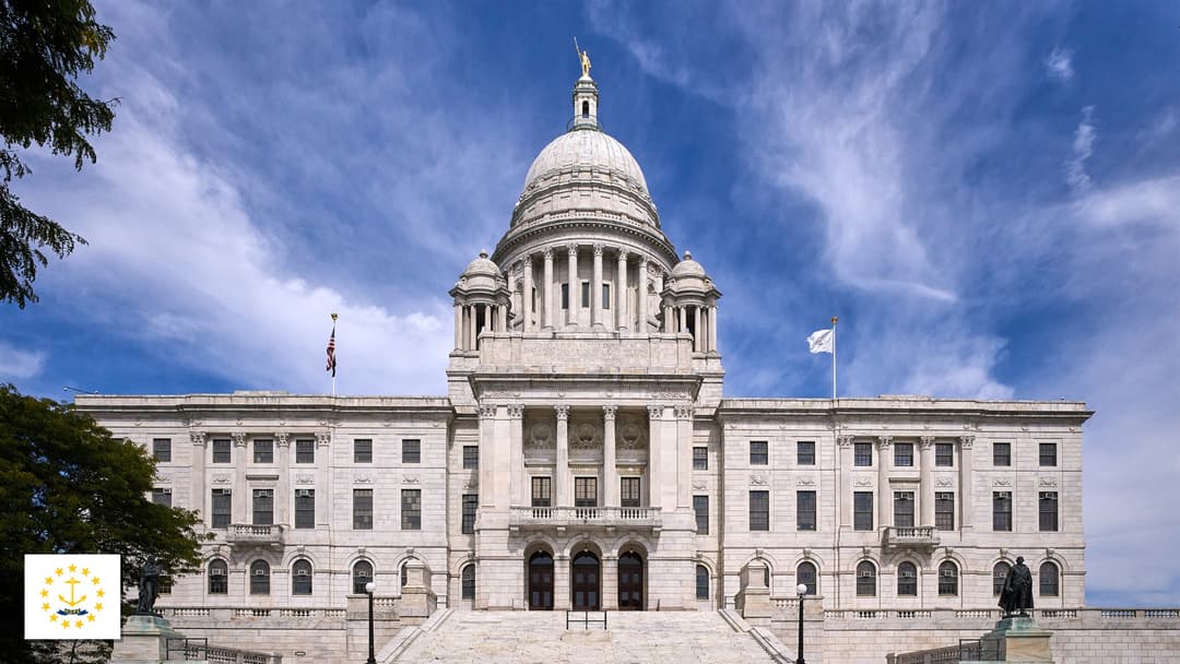 Rhode Island State House in Providence, Rhode Island with the Rhode Island state flag in the bottom left corner