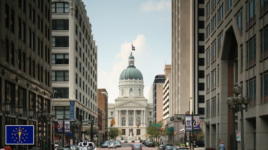 Indiana Statehouse in Indianapolis, Indiana with the Indiana state flag in the bottom left corner