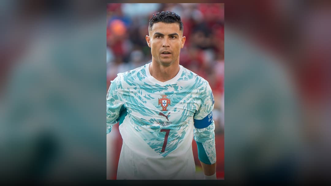 Cristiano Ronaldo standing proudly in the Portugal national team captain uniform.