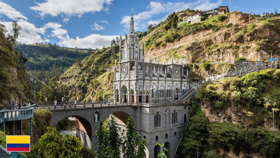 Las Lajas Sanctuary neo-Gothic basilica spanning the Guaitara River canyon with flag of Colombia in bottom-left corner