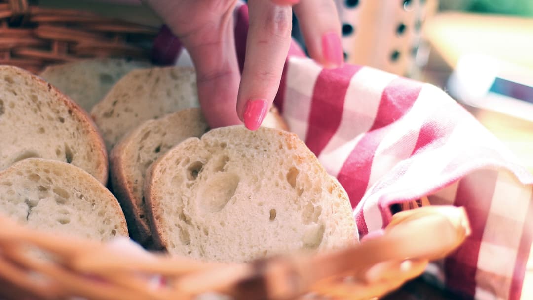 Sliced white bread loaf on table