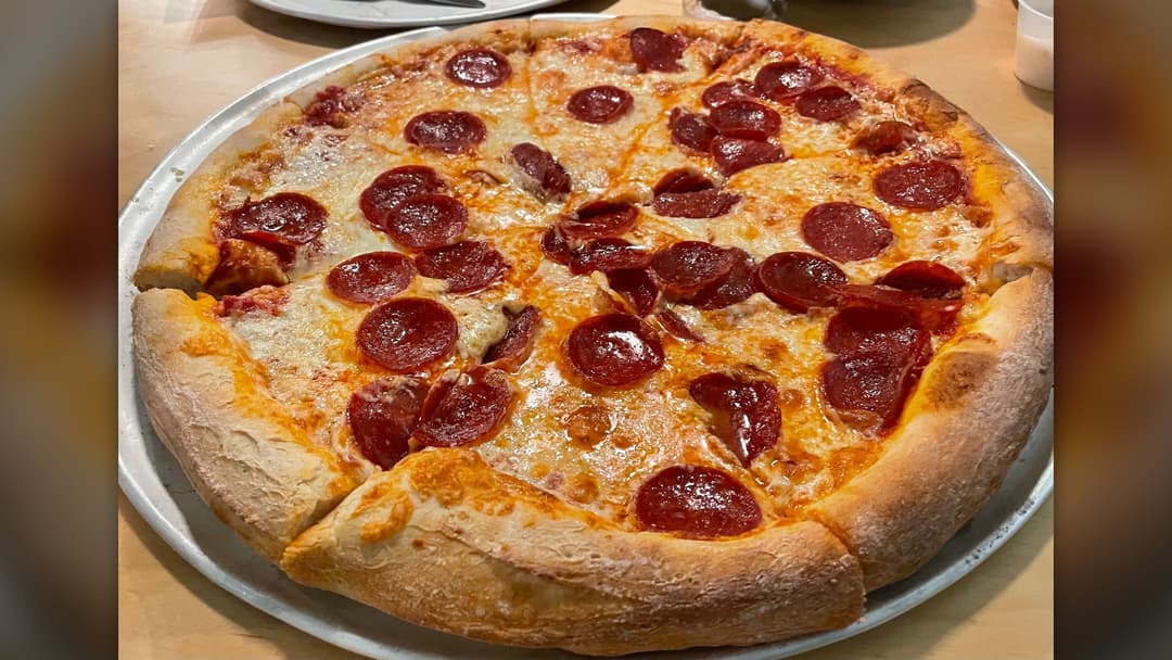 Baked pepperoni pizza on tray