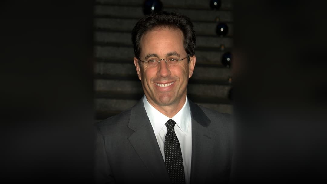 Comedian Jerry Seinfeld smiling at an evening gala in New York City.