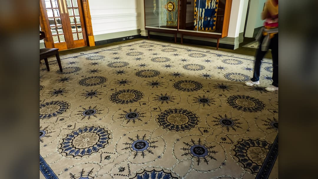 Foyer interior featuring wall-to-wall fitted patterned carpeting