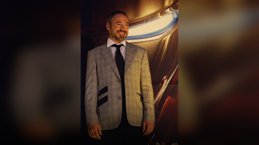 Robert Downey Jr. in a sharp suit at a red carpet event.