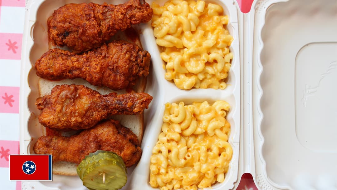Crispy cayenne-glazed Nashville hot chicken drumsticks with Tennessee flag overlay in bottom-left corner