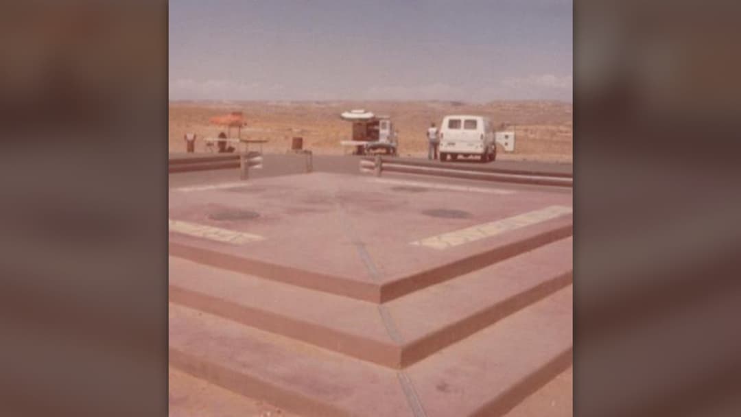Visitors standing on the brass seal at Four Corners Monument