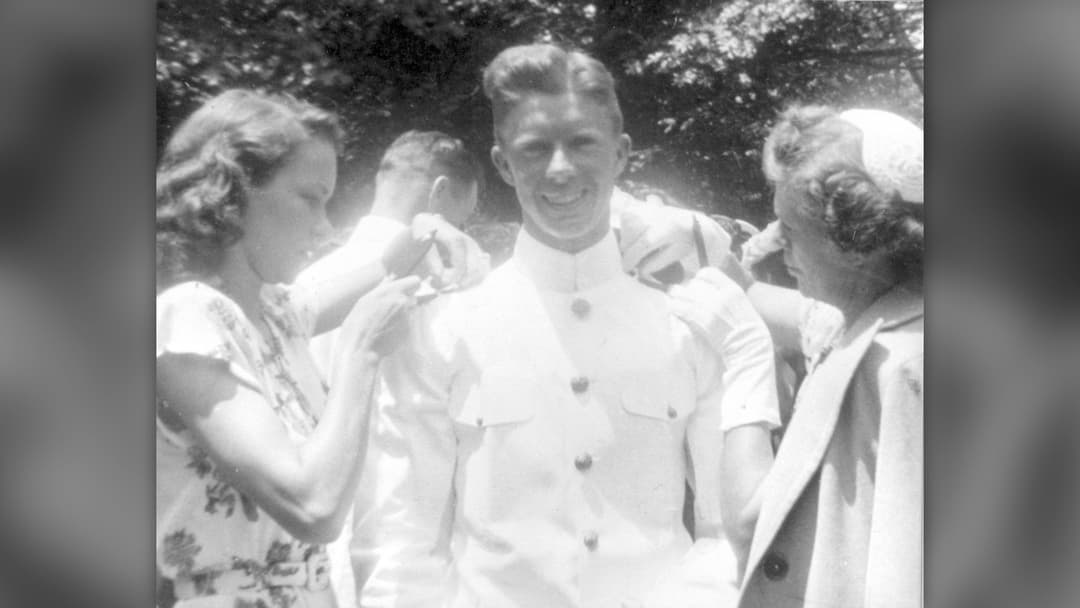 Jimmy Carter having his US Navy ensign bars pinned onto his uniform at his 1946 US Naval Academy graduation in Annapolis.